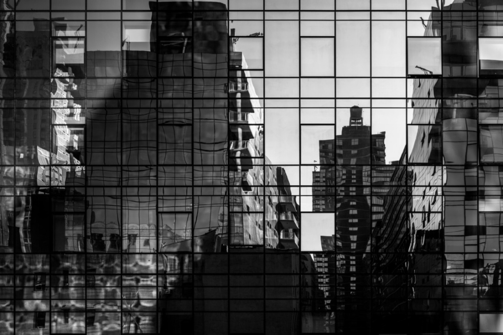 Abstract cityscape reflections in windows on a modern steel and glass skyscraper