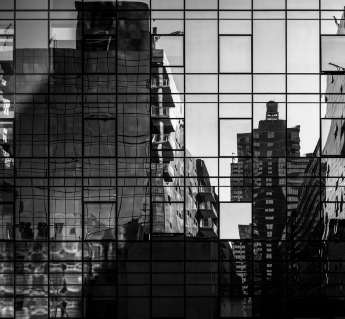 Abstract cityscape reflections in windows on a modern steel and glass skyscraper